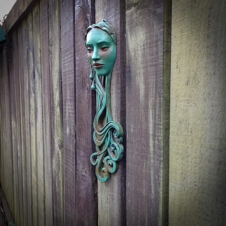 Art Nouveau inspired sculpture of beautiful female face with long stylised hair