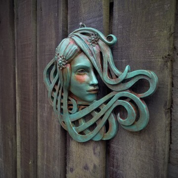 Art Nouveau inspired sculpture of beautiful female face with long stylised hair