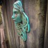 Art Nouveau inspired sculpture of beautiful female face with long stylised hair