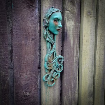 Art Nouveau inspired sculpture of beautiful female face with long stylised hair