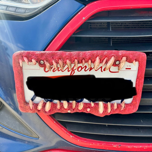 Creature teeth license plate