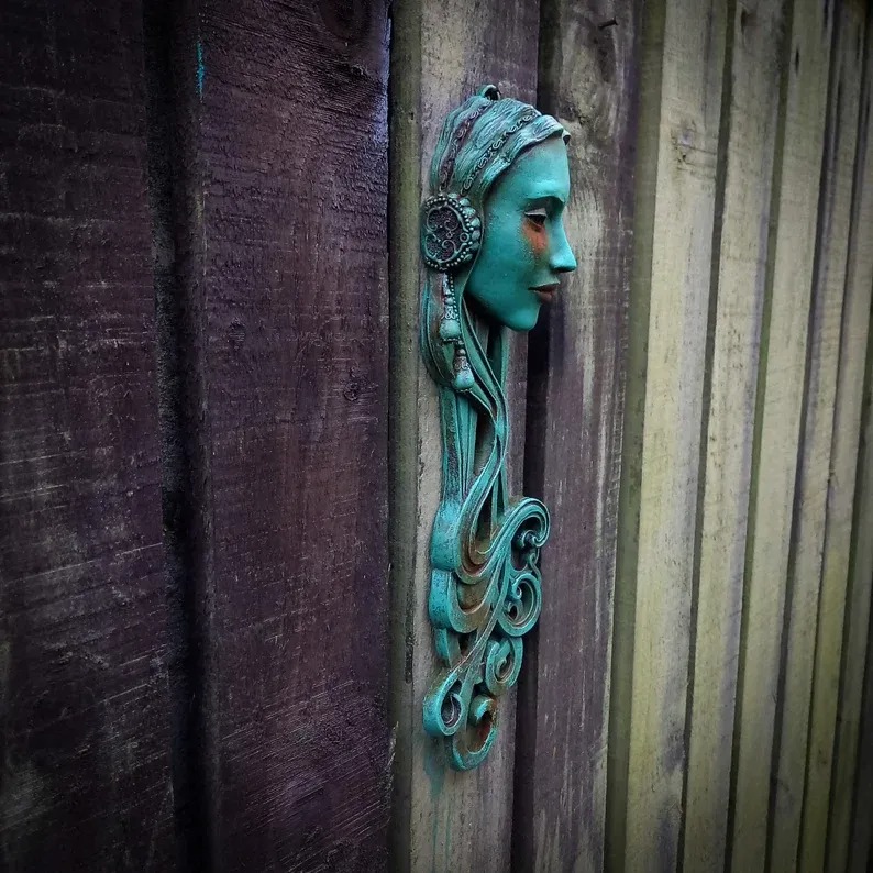 Art Nouveau inspired sculpture of beautiful female face with long stylised hair