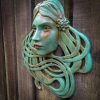 Art Nouveau inspired sculpture of beautiful female face with long stylised hair