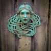 Art Nouveau inspired sculpture of beautiful female face with long stylised hair