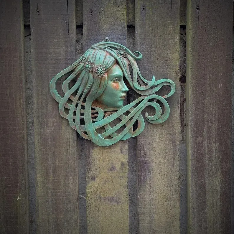 Art Nouveau inspired sculpture of beautiful female face with long stylised hair