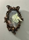 SPOOKY WALL SCULPTURES OFVICTORIAN GHOSTS EMERGINGFROM A MIRROR